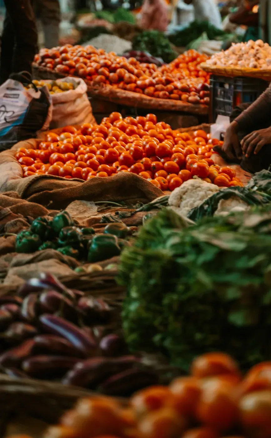 Tomatoes, greens and peppers laid out at the market