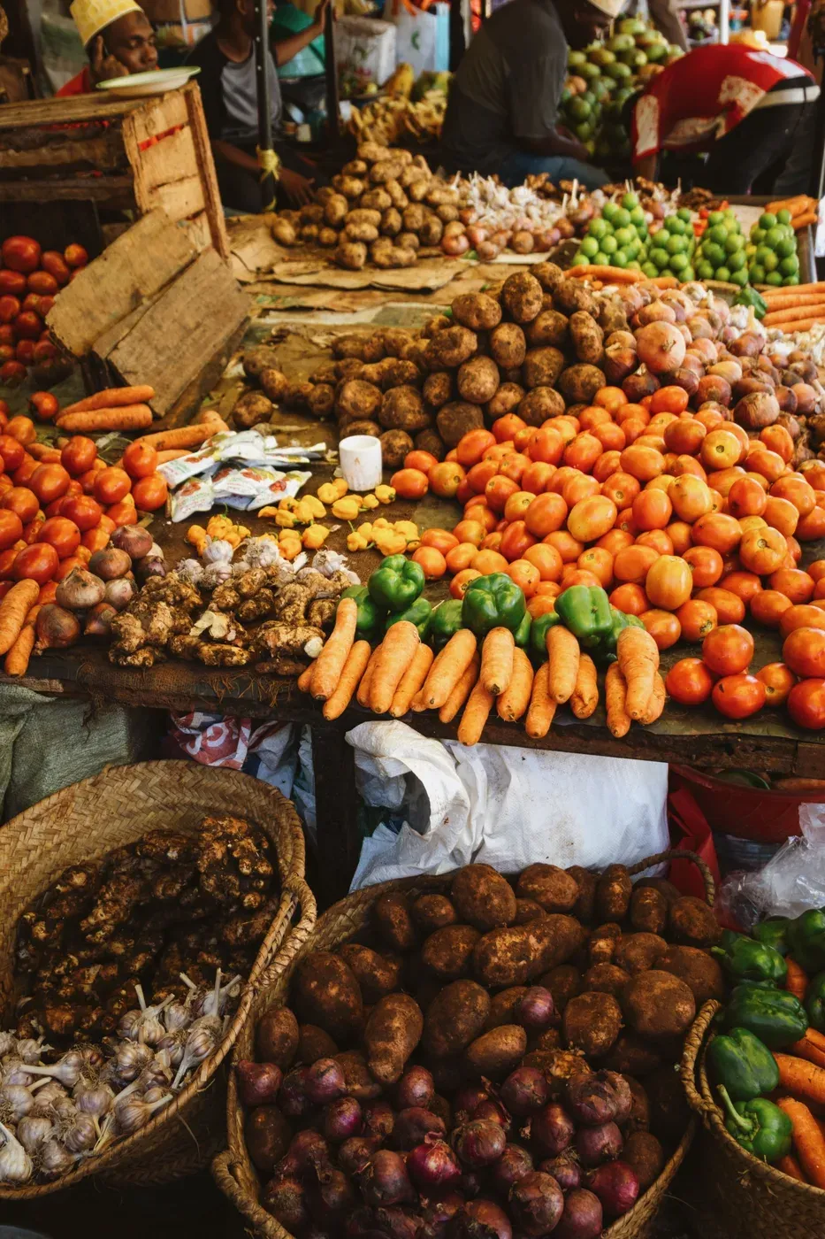 Tomatoes, carrots and onions on a market table